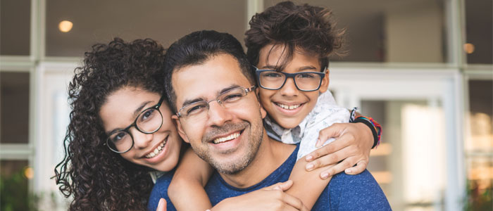 man holding his kids on his back